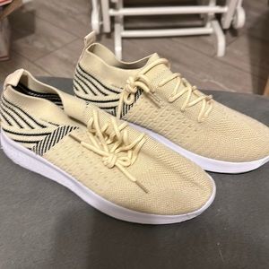 EUC tan and black tennis shoes. She & in